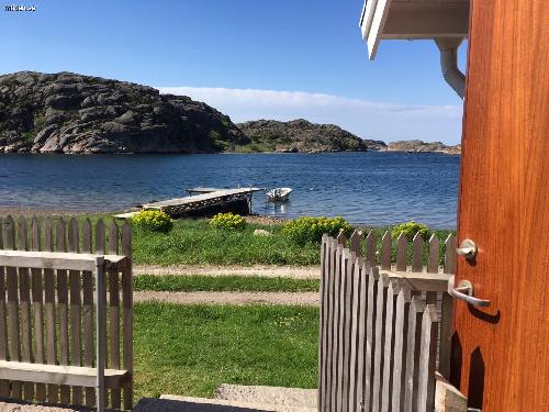 Red cottage next to the sea